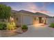 Beautiful home with a two-car garage, mature landscaping, and manicured lawn at sunset at 2967 Thayer Ter, The Villages, FL 32163
