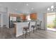 Spacious kitchen featuring stainless steel appliances, tile backsplash and a convenient breakfast bar at 2967 Thayer Ter, The Villages, FL 32163