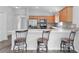 Bright kitchen featuring stainless steel appliances, a breakfast bar with seating, and sleek countertops at 2967 Thayer Ter, The Villages, FL 32163