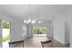 Open-concept living room with bright natural light, wood floors, ceiling fan and access to the patio at 2967 Thayer Ter, The Villages, FL 32163