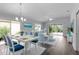Open-concept living and dining area with neutral decor, modern lighting, and sliding glass doors at 2967 Thayer Ter, The Villages, FL 32163