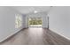 Bright, airy living room featuring wood floors and a sliding glass door leading to the outdoor patio at 2967 Thayer Ter, The Villages, FL 32163