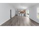 Bright, open floor plan features wood-look floors and kitchen with breakfast bar at 2967 Thayer Ter, The Villages, FL 32163