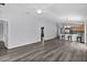 Bright, open floor plan features wood-look floors leading to kitchen area at 2967 Thayer Ter, The Villages, FL 32163