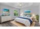 Stylishly decorated main bedroom with a tray ceiling and serene beach-themed decor at 2967 Thayer Ter, The Villages, FL 32163