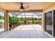 Covered patio with fan, overlooking a serene pond with waterfall feature at 2967 Thayer Ter, The Villages, FL 32163
