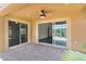 Covered outdoor patio with brick pavers and a ceiling fan, perfect for enjoying the outdoors at 2967 Thayer Ter, The Villages, FL 32163