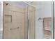 Shower features tile surround, built in soap niche, and glass door at 2967 Thayer Ter, The Villages, FL 32163