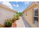Charming side yard featuring a brick pathway and colorful landscaping at 2967 Thayer Ter, The Villages, FL 32163