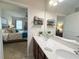 Bright bathroom with double vanity, quartz countertops, and neutral color palette at 3181 Hill Point St, Minneola, FL 34715