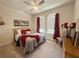Comfortable bedroom featuring a ceiling fan, two windows and coordinated decor at 3181 Hill Point St, Minneola, FL 34715