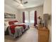 Comfortable bedroom featuring a ceiling fan, two windows and coordinated decor at 3181 Hill Point St, Minneola, FL 34715