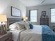 Bedroom featuring neutral colors, ceiling fan, and a picture window at 3181 Hill Point St, Minneola, FL 34715