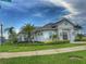 Beautiful community clubhouse with lush landscaping, palm trees, and well-manicured lawns at 3181 Hill Point St, Minneola, FL 34715