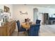 Dining area features round wood table, tufted dining chairs, and wood buffet table at 3181 Hill Point St, Minneola, FL 34715