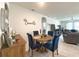 Dining area features round wood table, tufted dining chairs, and decor at 3181 Hill Point St, Minneola, FL 34715