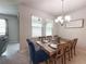Dining room featuring a chandelier, large windows, and seating for six at 3181 Hill Point St, Minneola, FL 34715
