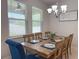 Dining room featuring a chandelier, large windows, and seating for six at 3181 Hill Point St, Minneola, FL 34715