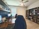 Spacious home office featuring a built-in desk, shelving, and comfortable seating at 3181 Hill Point St, Minneola, FL 34715
