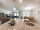 Open concept kitchen featuring granite countertops, stainless steel sink, and modern pendant lighting at 3181 Hill Point St, Minneola, FL 34715