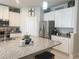 Kitchen with granite countertops, stainless steel appliances, and white cabinets at 3181 Hill Point St, Minneola, FL 34715