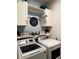 Efficient laundry room featuring modern washer and dryer units at 3181 Hill Point St, Minneola, FL 34715