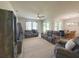 Open concept living room with tile floors, ceiling fan, and view of the dining area at 3181 Hill Point St, Minneola, FL 34715