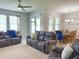 Open concept living room with tile floors, ceiling fan, and view of the dining area at 3181 Hill Point St, Minneola, FL 34715