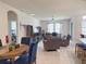 Spacious living room features tile floors, ceiling fan, and large windows for natural light at 3181 Hill Point St, Minneola, FL 34715
