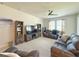 Bright living room features plush sofas, area rug, and entertainment center at 3181 Hill Point St, Minneola, FL 34715