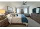 Comfortable main bedroom featuring a ceiling fan, soft lighting, and soothing decor at 3181 Hill Point St, Minneola, FL 34715