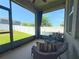 Relaxing screened-in patio featuring comfortable wicker furniture and a beautiful view of the fenced backyard at 3181 Hill Point St, Minneola, FL 34715