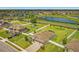 Aerial view of home featuring a large yard, lake views, and a paver driveway at 3222 San Leo Dr, Orlando, FL 32820