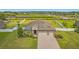 Stunning aerial view showcasing the home, lush landscaping, and fenced yard near community pond at 3222 San Leo Dr, Orlando, FL 32820