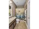 Bright bathroom featuring granite counters, wood cabinets, and a bathtub with decorative shower curtain at 3222 San Leo Dr, Orlando, FL 32820