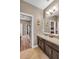 Bathroom featuring wood cabinets, tile floors, and a large mirror at 3222 San Leo Dr, Orlando, FL 32820