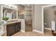 Well-lit bathroom featuring granite counters, dark wood cabinets, and a tiled glass shower at 3222 San Leo Dr, Orlando, FL 32820