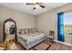 Bedroom showcasing a charming bed with storage, complemented by wood laminate flooring and a window at 3222 San Leo Dr, Orlando, FL 32820