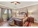 Serene bedroom with wood floors, large window, tray ceiling, and traditional furnishings at 3222 San Leo Dr, Orlando, FL 32820