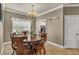 Cozy dining area features a round wooden table, chandelier, and bright natural light at 3222 San Leo Dr, Orlando, FL 32820