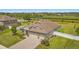 Close up aerial view of an exterior showing manicured landscaping, a driveway, and lake views at 3222 San Leo Dr, Orlando, FL 32820