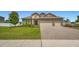 Charming single-Gathering home with a well-manicured lawn and a paver driveway leading to a two-car garage at 3222 San Leo Dr, Orlando, FL 32820