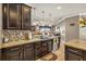 Gourmet kitchen featuring dark wood cabinetry, mosaic backsplash, and granite countertops at 3222 San Leo Dr, Orlando, FL 32820