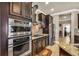 Modern kitchen features stainless steel appliances, granite countertops, and dark wood cabinetry at 3222 San Leo Dr, Orlando, FL 32820