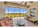Relaxing screened lanai featuring tile flooring, comfortable seating, ceiling fan, and scenic backyard view at 3222 San Leo Dr, Orlando, FL 32820