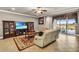 Well-lit living area with plush seating, sliding glass doors to the patio, and neutral color palette at 3222 San Leo Dr, Orlando, FL 32820
