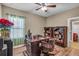 Office with a dark wood desk, a rolling leather chair and built in shelves at 3222 San Leo Dr, Orlando, FL 32820
