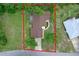Aerial view of the property showcasing its layout, mature trees, and proximity to surrounding neighborhood at 33 Palm Dr, Yalaha, FL 34797