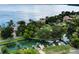 Aerial view of canal front homes with docks and boats, surrounded by lush greenery and waterways at 33 Palm Dr, Yalaha, FL 34797