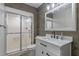 Modern bathroom featuring a beautifully tiled shower with glass door and updated vanity at 33 Palm Dr, Yalaha, FL 34797